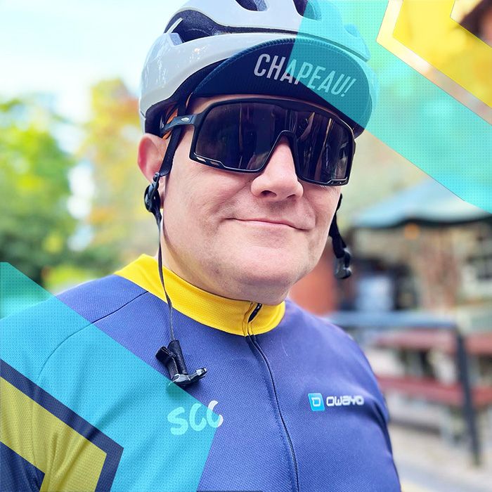 A man representing Surrey Cycling Club sporting a cycling helmet and sunglasses.