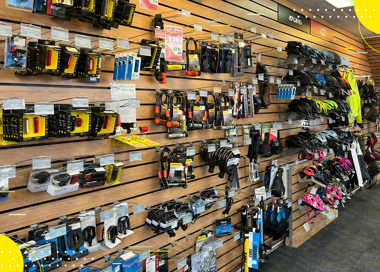 A store with a lot of different items on the wall, featuring Fudges Cycles in a partnership.