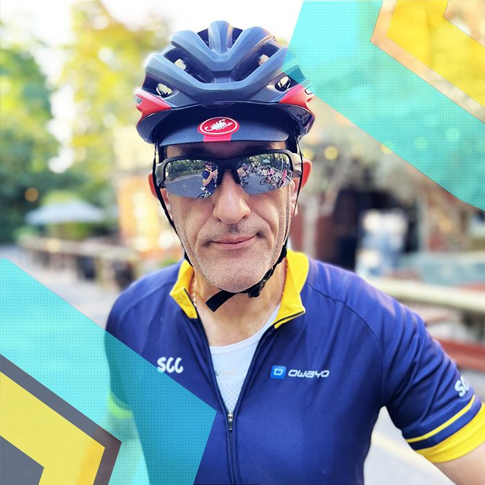 A cyclist wearing a bike helmet and sunglasses.