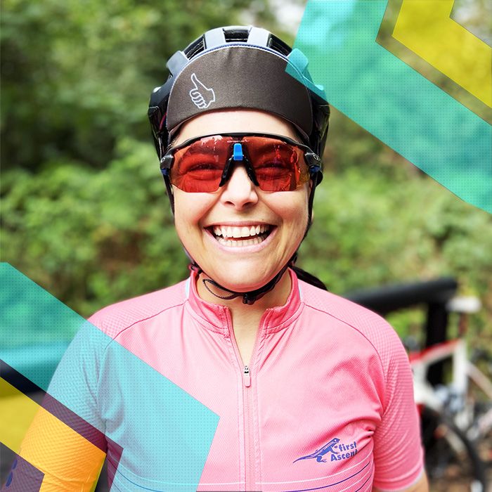 A woman wearing a pink bike helmet and sunglasses at a Surrey Cycling Club.